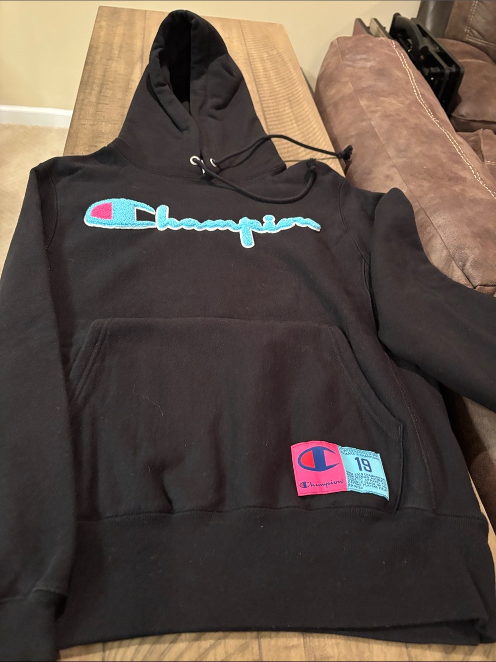 Champion Black Hoodie with Blue Script and Pink Patch